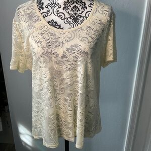 Sheer lace white shirt with floral design.